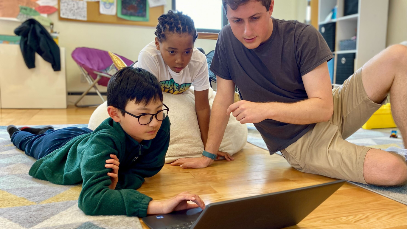 kids learning curriculum together at computer